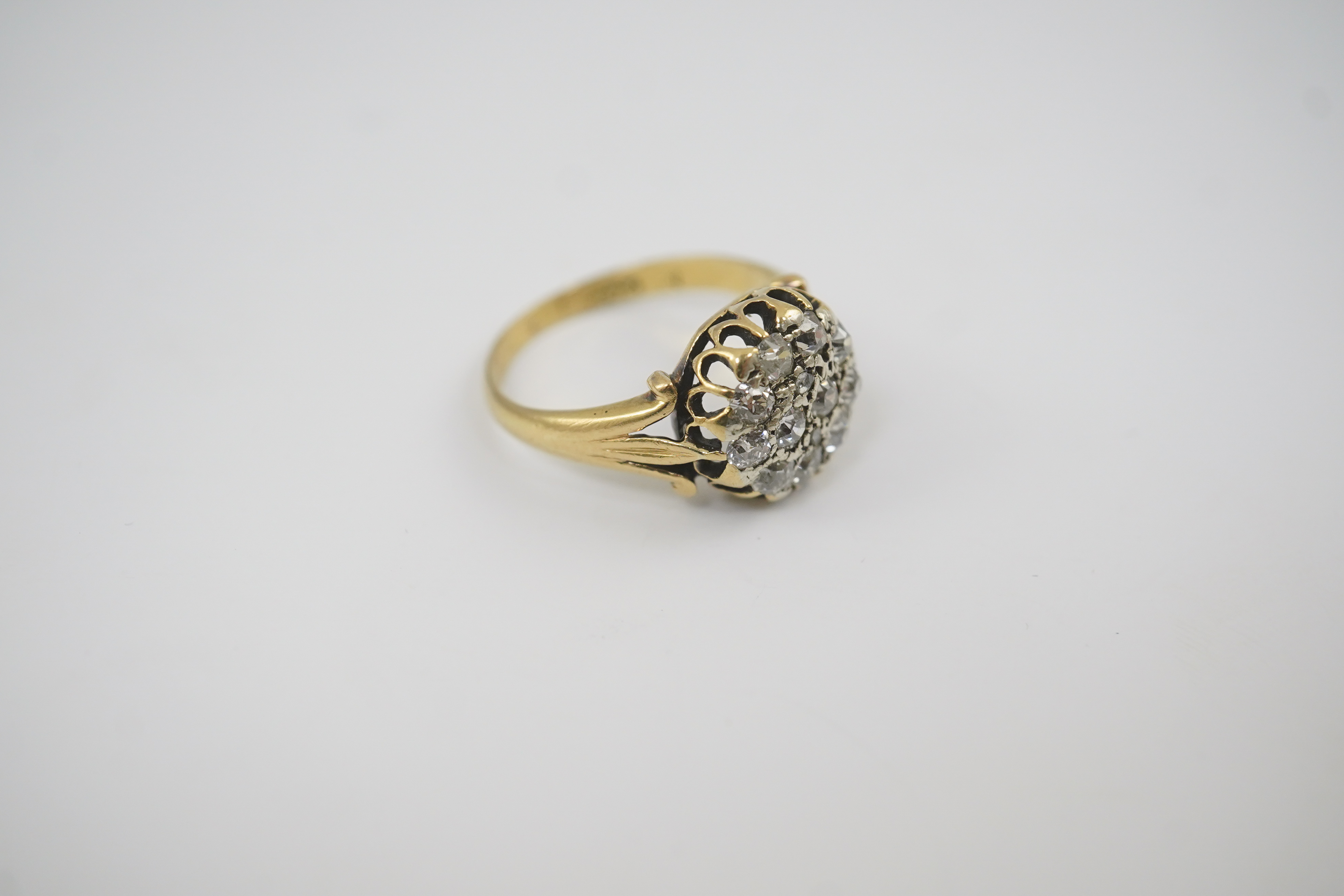 An early to mid 20th century gold and diamond set circular cluster ring